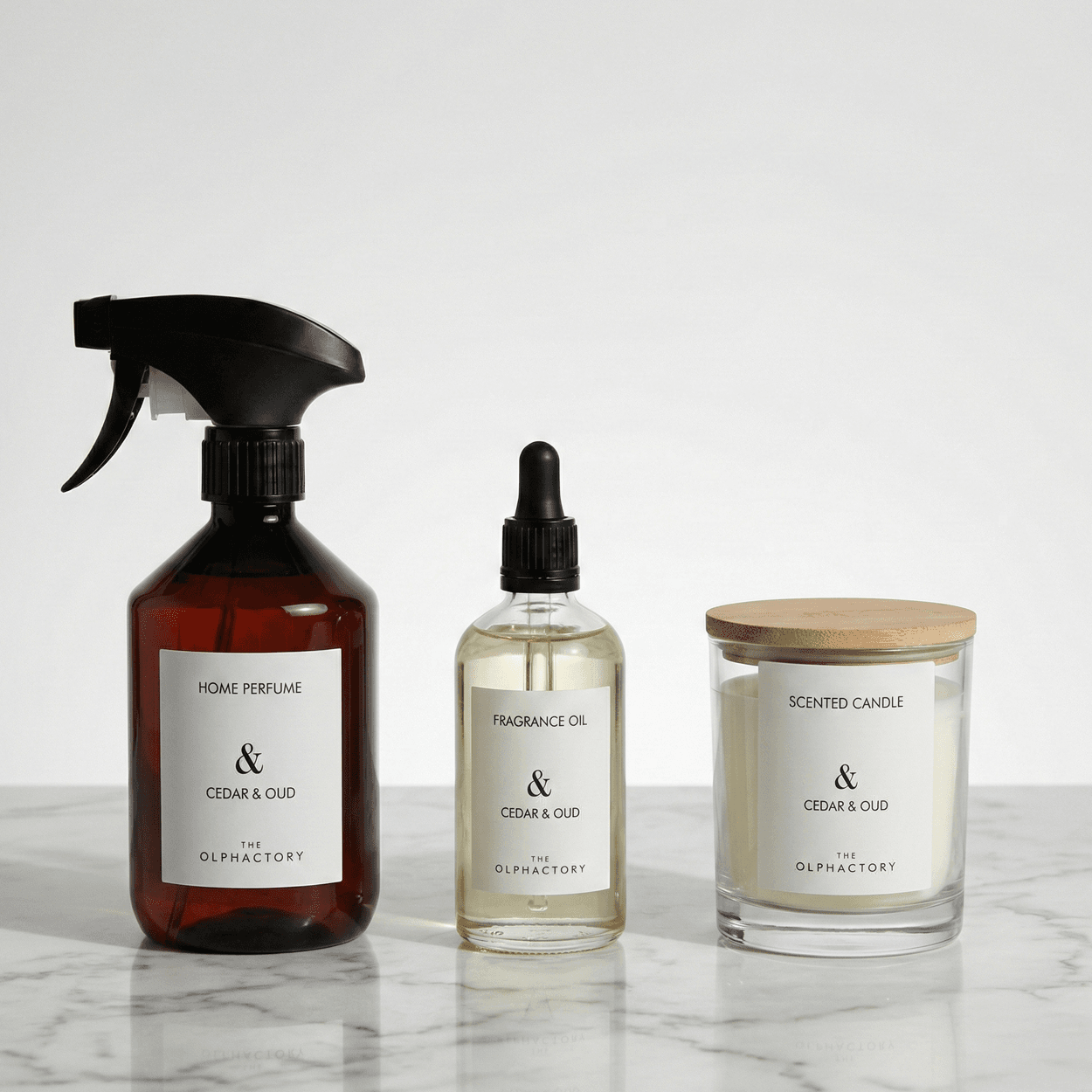 The Olphactory trio: interieurspray, geurolie en geurkaars op marmer